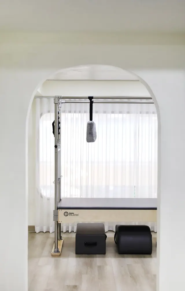 Pilates cadillac equipment in a private session room